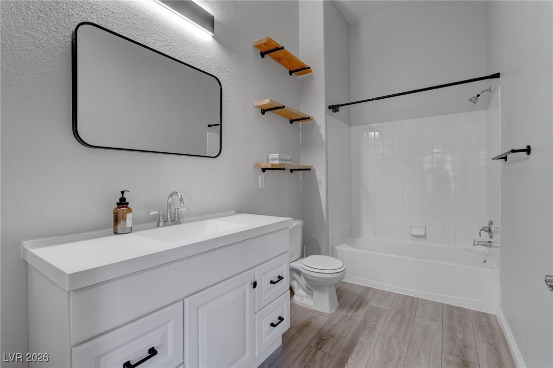 2305 West Horizon Ridge Parkway, Unit 3921 Henderson, NV 89052 - Photo 5 of 31 Full bathroom with wood finished floors, vanity, and shower combination
