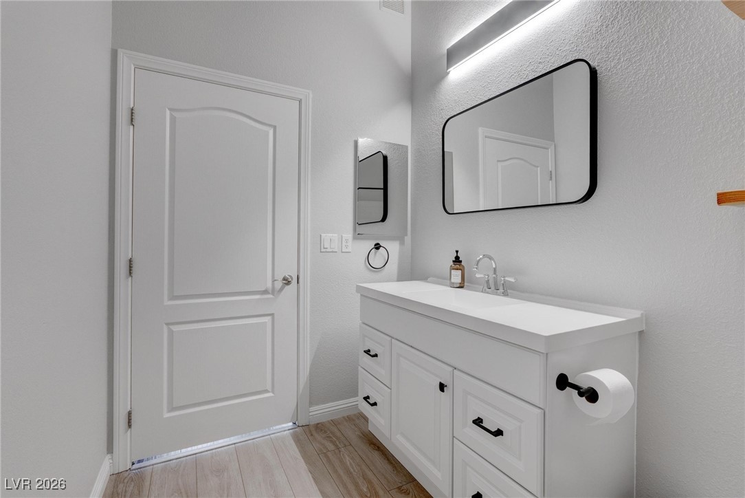 2305 West Horizon Ridge Parkway, Unit 3921 Henderson, NV 89052 - Photo 6 of 31 Bathroom with vanity and wood finished floors