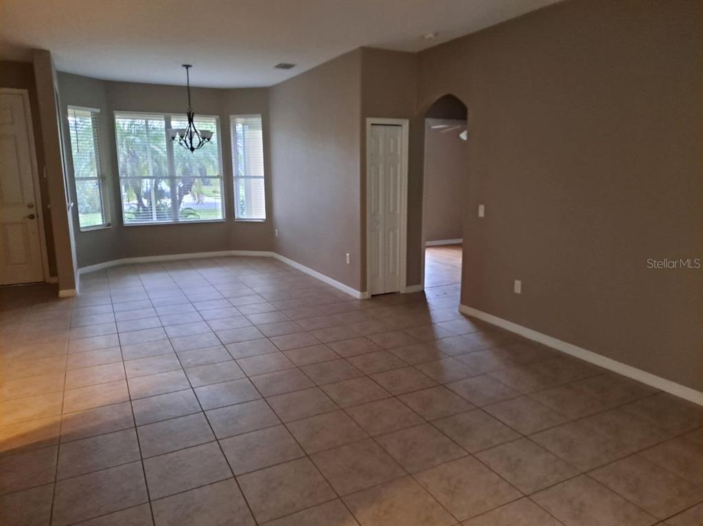 13534 Biscayne Grove Lane Grand Island, FL 32735 - Photo 4 of 12 an empty room with windows and entrance