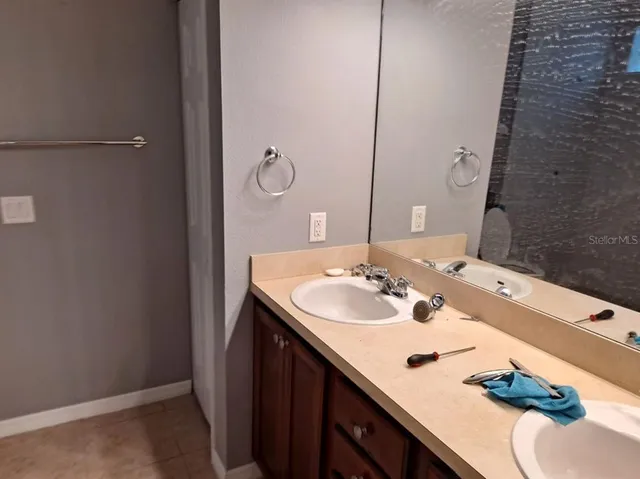a bathroom with a sink vanity and a mirror