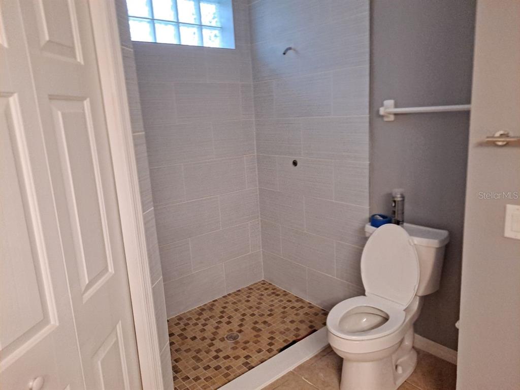 13534 Biscayne Grove Lane Grand Island, FL 32735 - Photo 10 of 12 a bathroom with a toilet and a shower