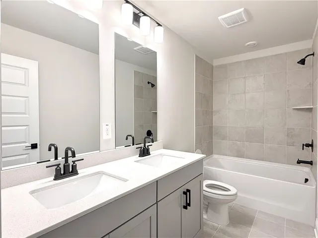 a bathroom with a sink a toilet and bathtub