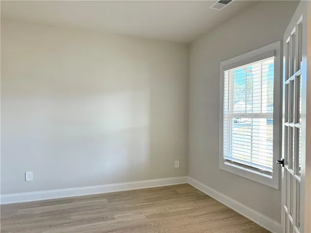 wooden floor in an empty room with a window