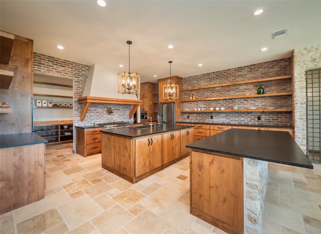 a kitchen with stainless steel appliances granite countertop a stove and a refrigerator