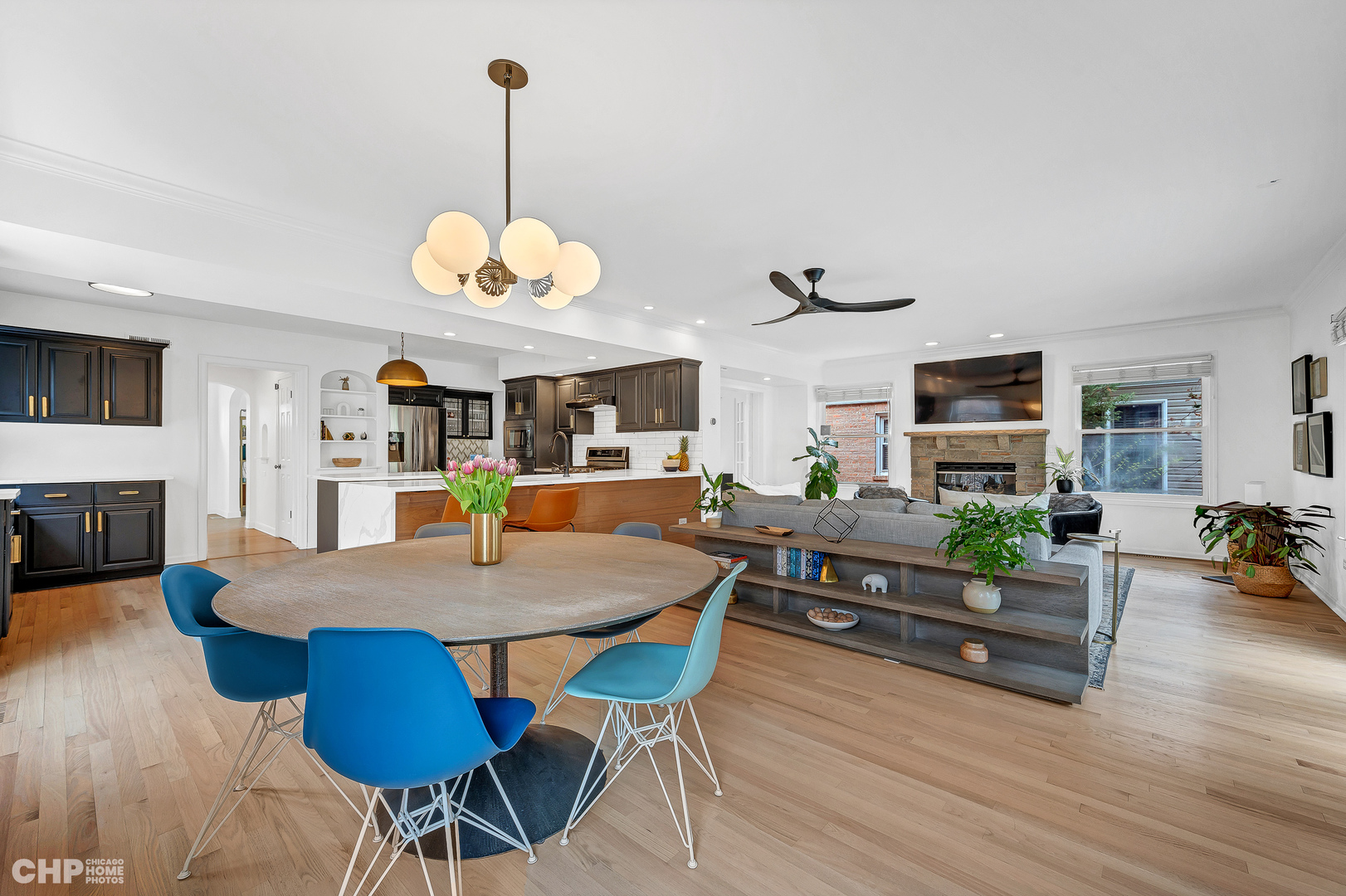 316 Nuttall Road Riverside, IL 60546 - Photo 13 of 40 a view of a dining room and livingroom with furniture wooden floor a rug a fireplace