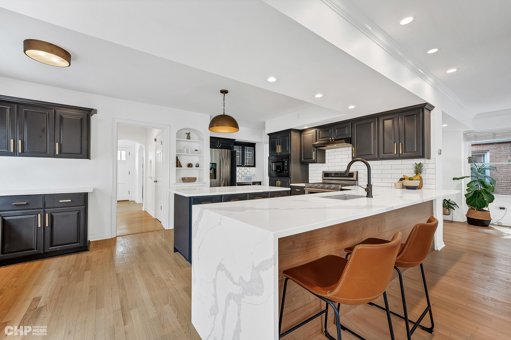 316 Nuttall Road Riverside, IL 60546 - Photo 6 of 40 a kitchen with stainless steel appliances a sink a stove a refrigerator cabinets and a dining table