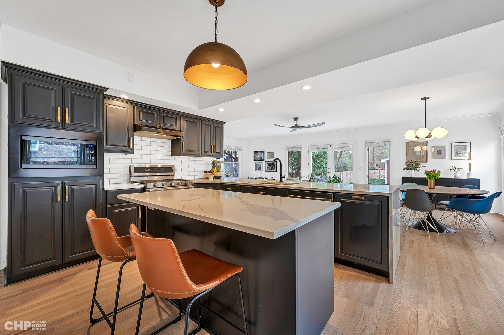 316 Nuttall Road Riverside, IL 60546 - Photo 8 of 40 a kitchen with stainless steel appliances granite countertop a table chairs and a refrigerator