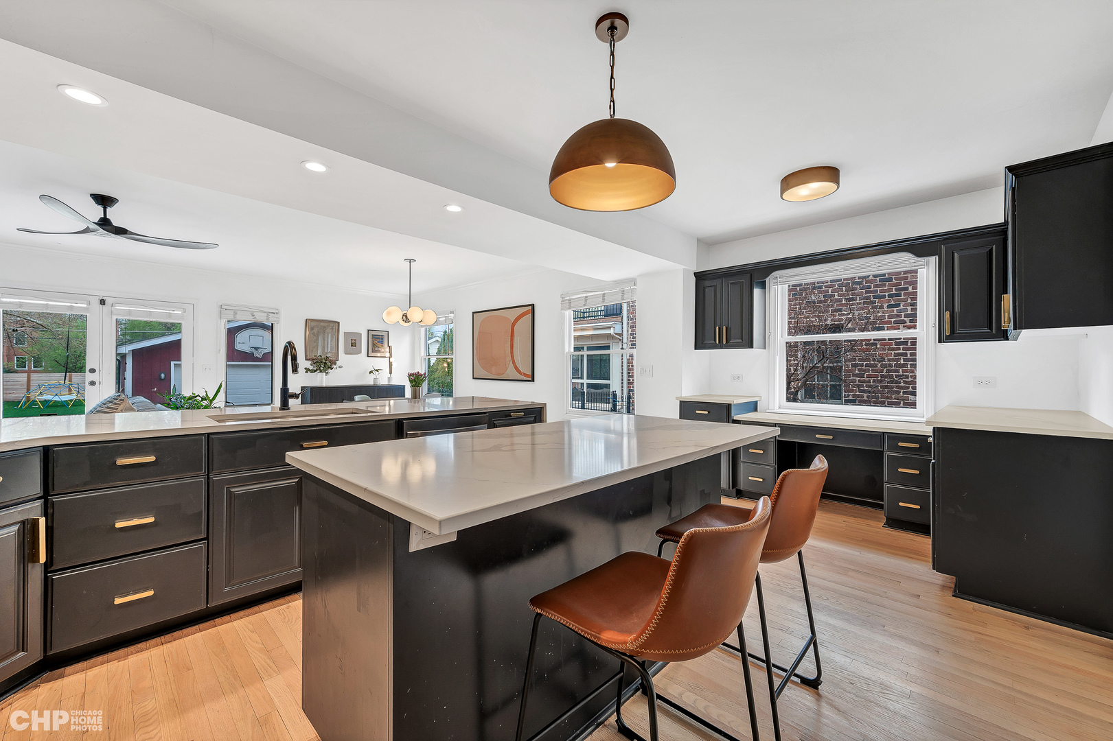 316 Nuttall Road Riverside, IL 60546 - Photo 9 of 40 a kitchen with a stove a kitchen island a dining table and chairs with wooden floor