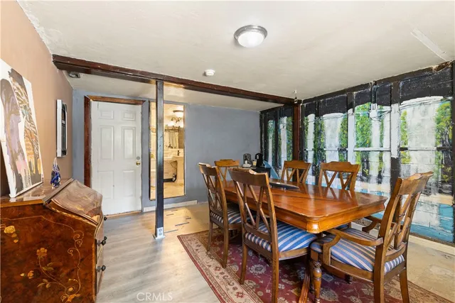 a dining room with furniture and wooden floor
