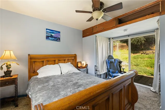 a bedroom with furniture and a large window