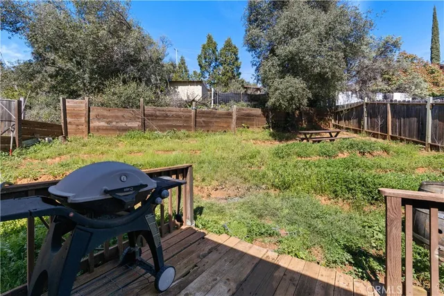 a view of deck with furniture and a yard