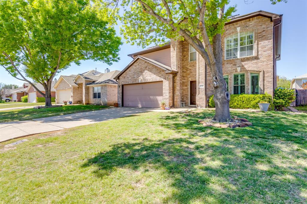 4816 Sleepy Ridge Circle Fort Worth, TX 76133 - Photo 2 of 36 Traditional-style house featuring driveway, brick siding, a front yard, and a garage