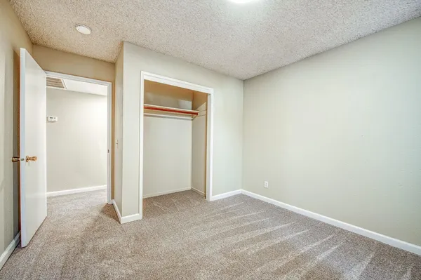 a view of an empty room and closet area