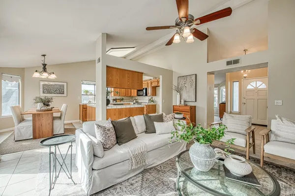 a living room with furniture and a chandelier