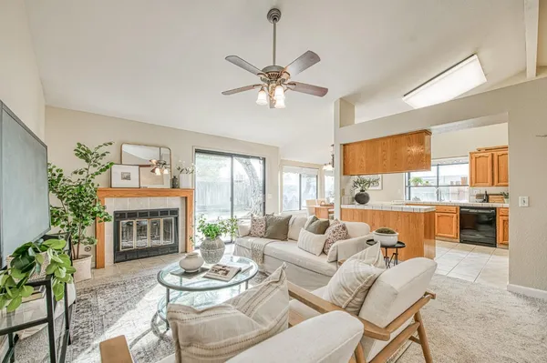 a living room with furniture a fireplace and a chandelier