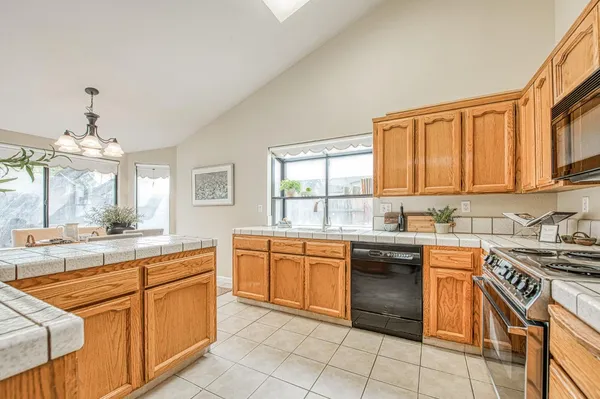 a kitchen with stainless steel appliances granite countertop a sink and cabinets