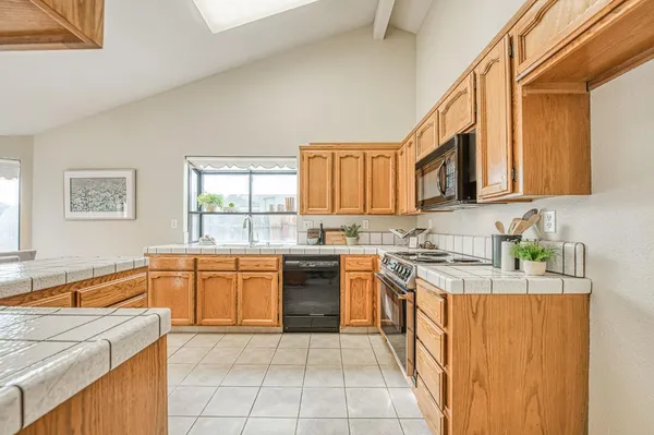 a kitchen with stainless steel appliances granite countertop a sink and cabinets