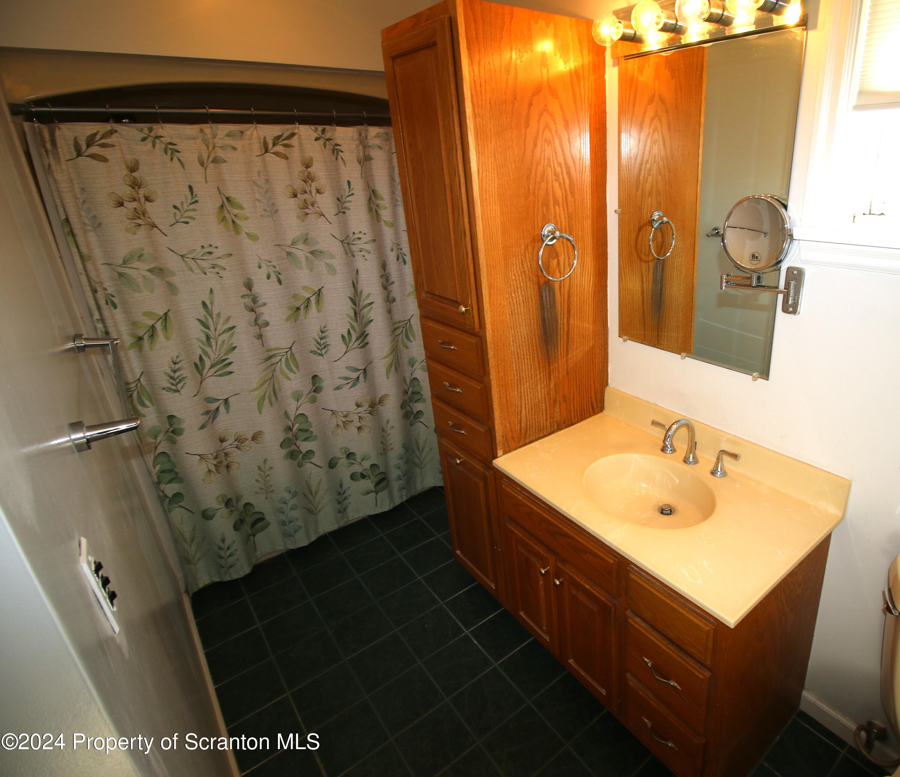 1105 Rundle Street Scranton, PA 18504 - Photo 13 of 30 a bathroom with a sink and a mirror