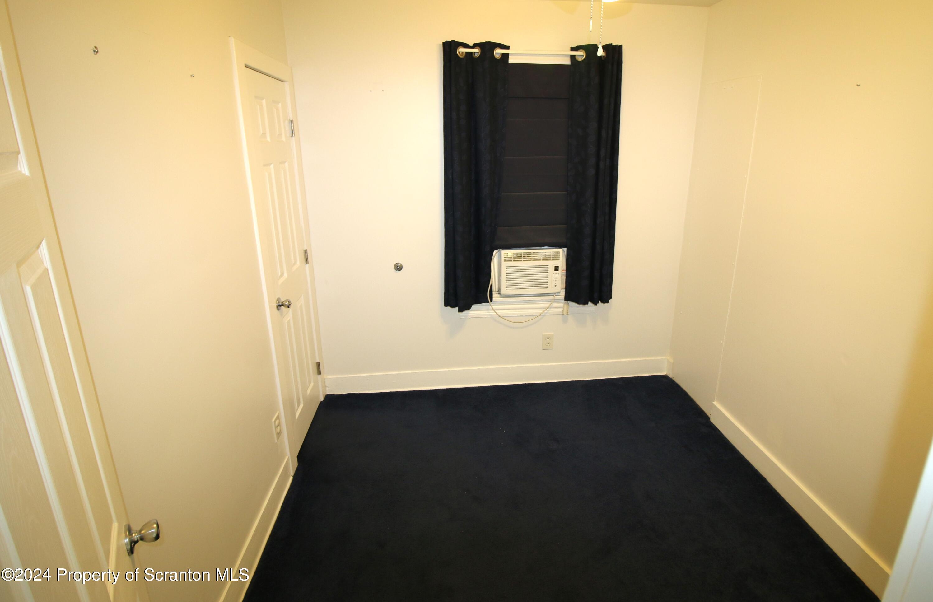 1105 Rundle Street Scranton, PA 18504 - Photo 15 of 30 an empty room with wooden floor and cabinet