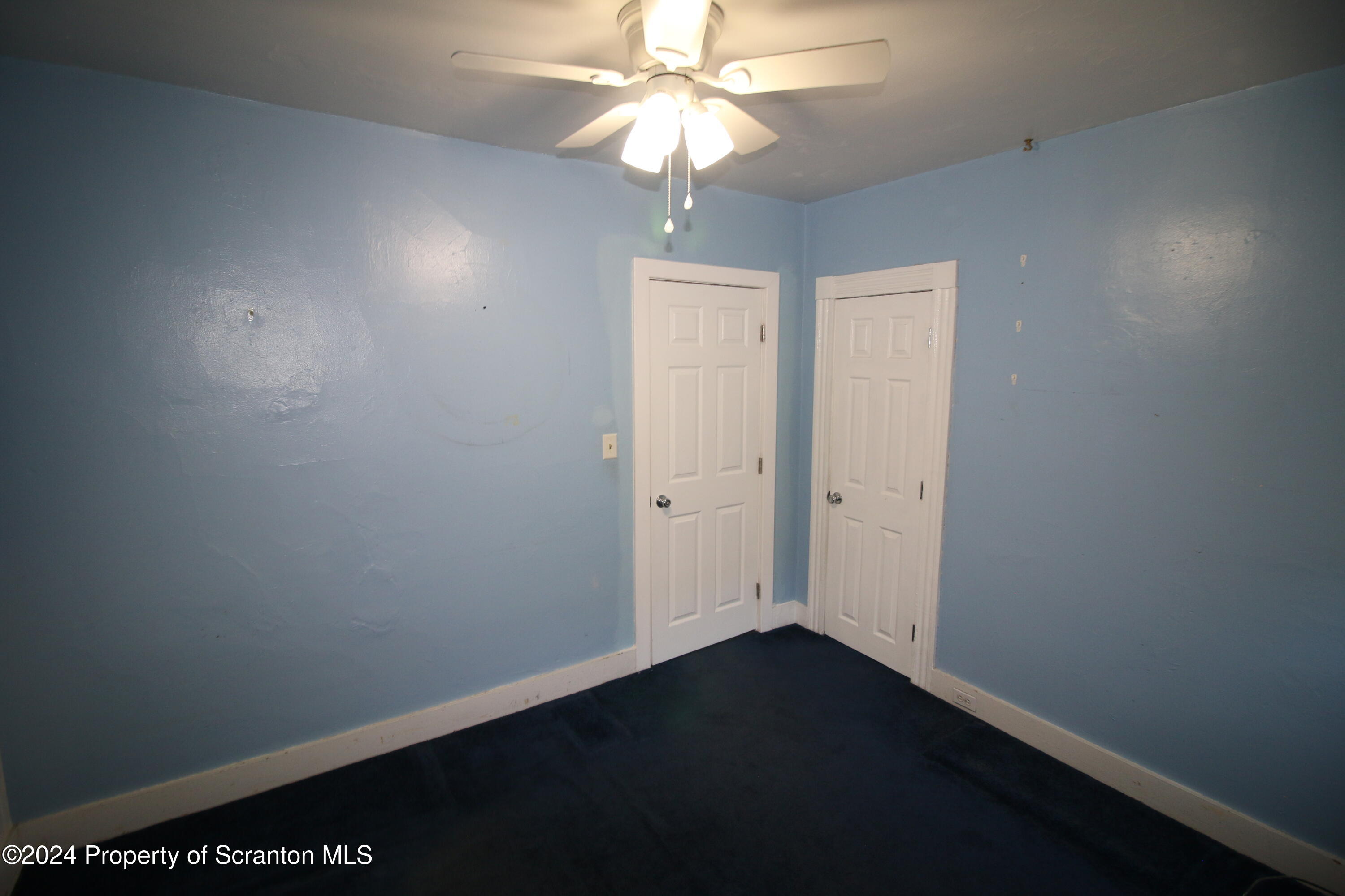 1105 Rundle Street Scranton, PA 18504 - Photo 17 of 30 a view of a hallway with a chandelier fan