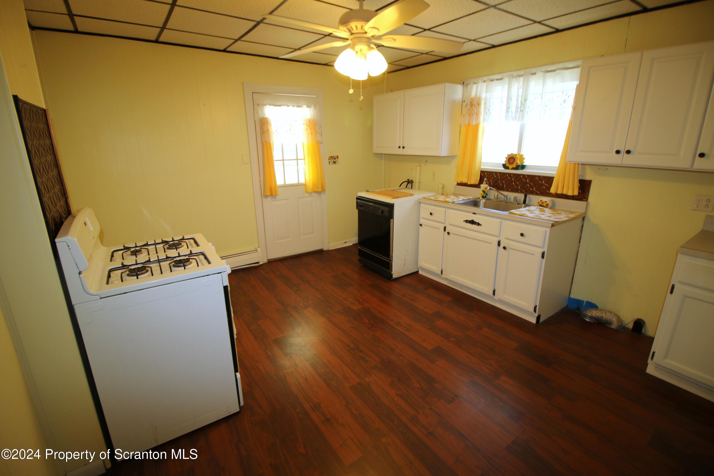 1105 Rundle Street Scranton, PA 18504 - Photo 22 of 30 a kitchen with sink a refrigerator and a stove