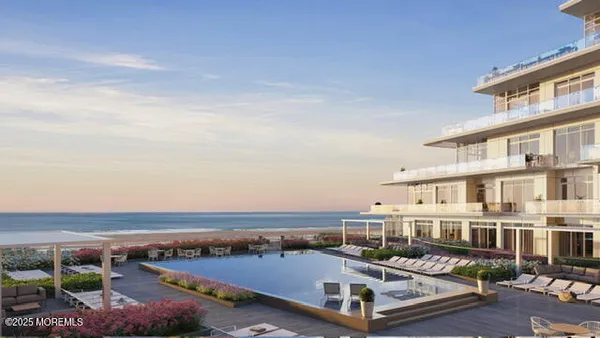 an aerial view of a building with swimming pool and outdoor seating