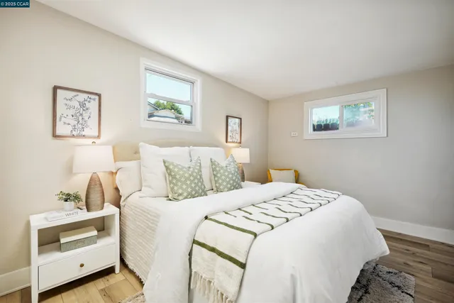 a bedroom with a bed and a painting on the wall