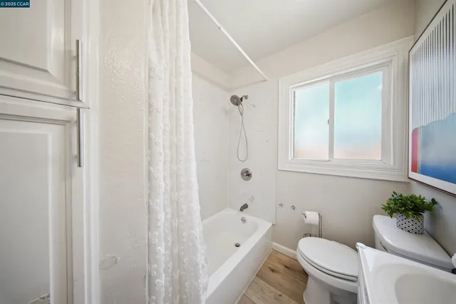 a bathroom with a toilet a sink and bathtub