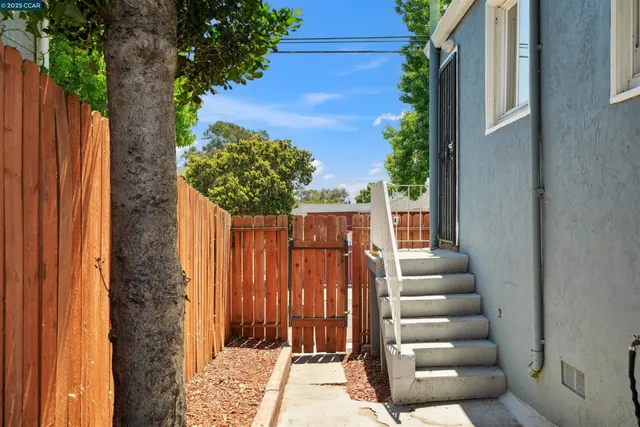 a view of a pathway of a house with wooden floor and fence