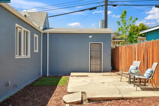 a backyard of a house with outdoor seating