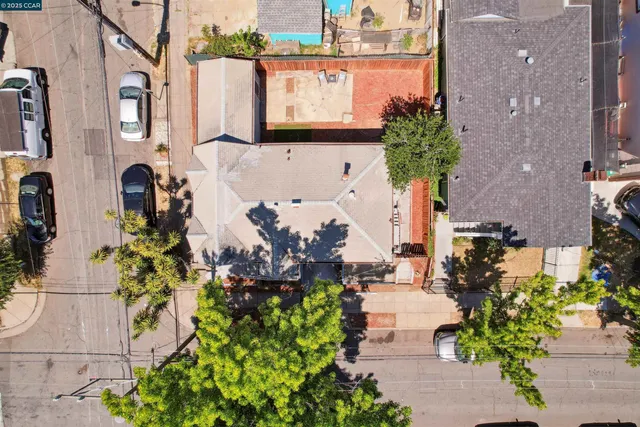 a view of a street with potted plants