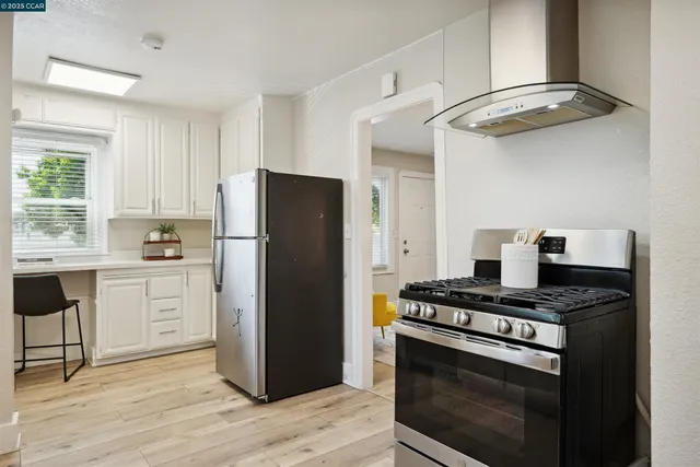 a kitchen with a stove and a refrigerator