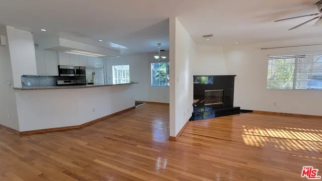 a view of a kitchen with cabinets and wooden floor