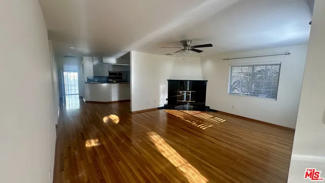 a view of kitchen and hall with wooden floor