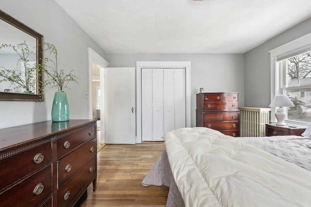 71 Governors Road Milton, MA 02186 - Photo 16 of 25 a bedroom with a bed and a dresser with mirror
