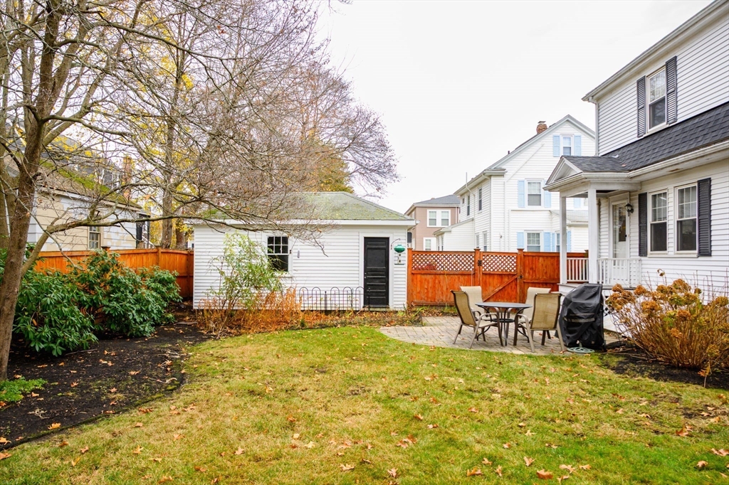 71 Governors Road Milton, MA 02186 - Photo 23 of 25 a backyard of a house with yard and outdoor seating