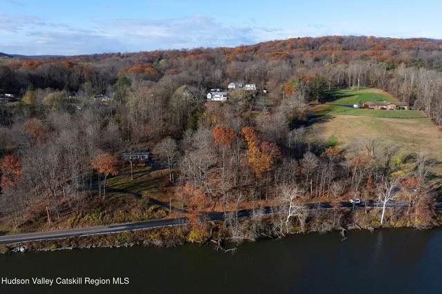 an aerial view of a houses with ocean view