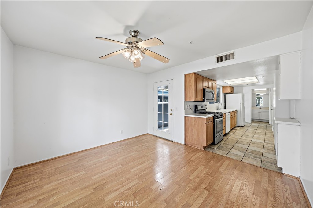 8317 College Avenue Whittier, CA 90605 - Photo 11 of 41 a view of kitchen with wooden floor and window