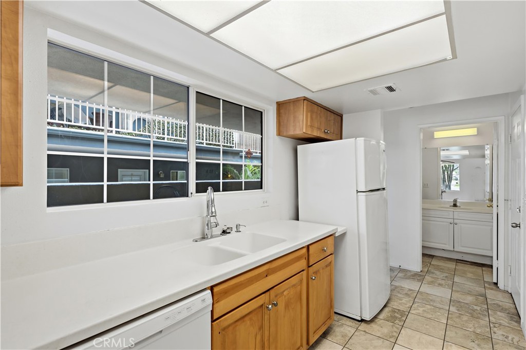 8317 College Avenue Whittier, CA 90605 - Photo 13 of 41 a view of a kitchen with a sink and refrigerator
