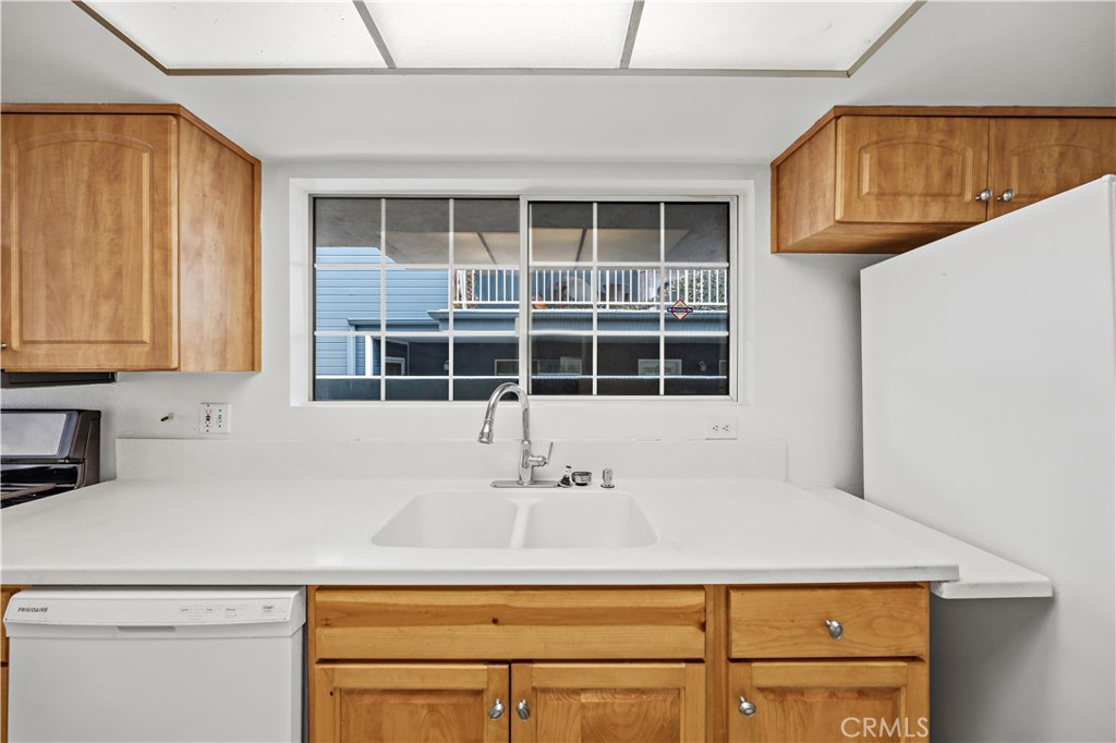 8317 College Avenue Whittier, CA 90605 - Photo 14 of 41 a close view of a refrigerator a sink and cabinets