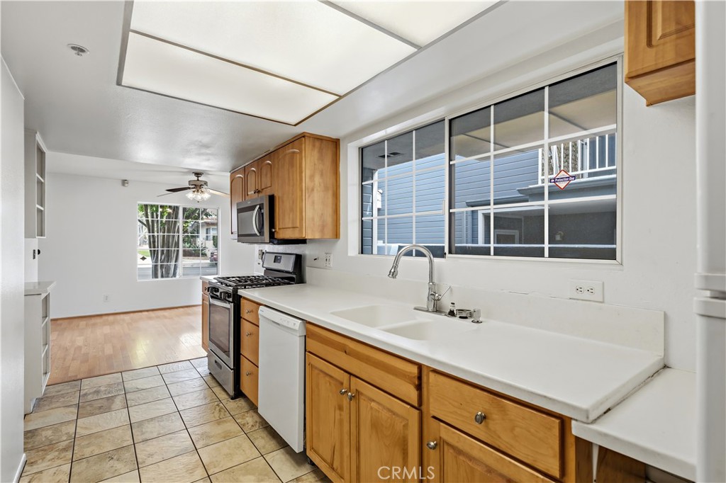 8317 College Avenue Whittier, CA 90605 - Photo 15 of 41 a kitchen with a sink and a stove top oven