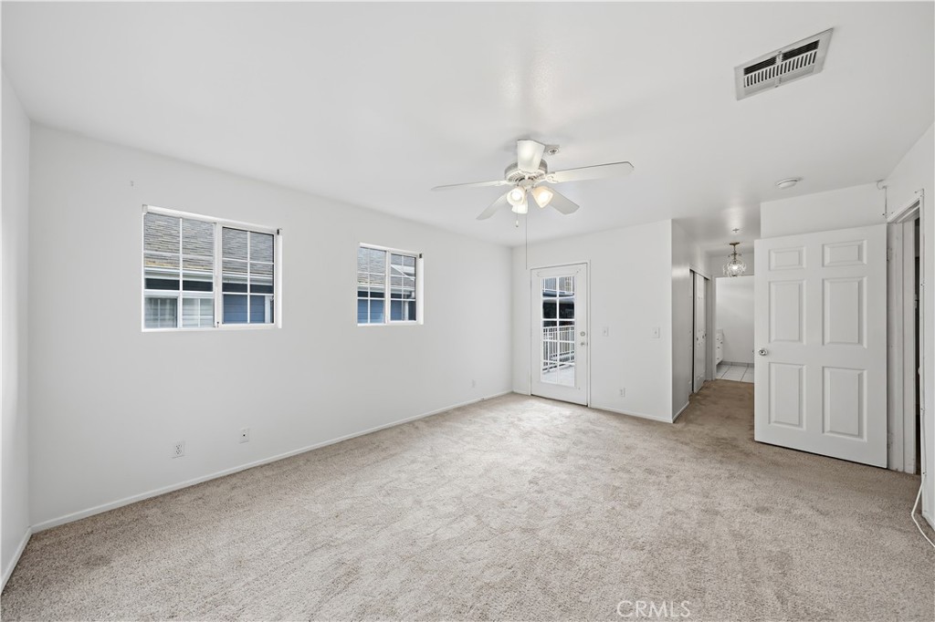 8317 College Avenue Whittier, CA 90605 - Photo 19 of 41 an empty room with windows and ceiling fan
