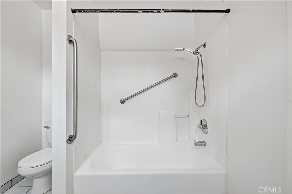 8317 College Avenue Whittier, CA 90605 - Photo 21 of 41 a bathroom with a bathtub and a shower