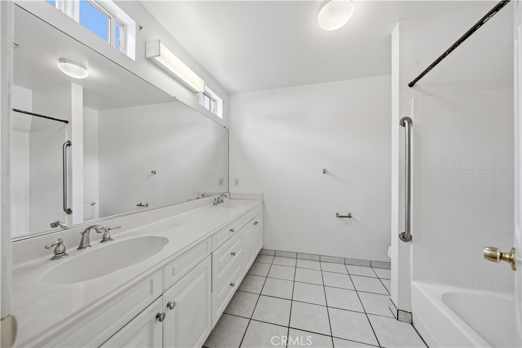 8317 College Avenue Whittier, CA 90605 - Photo 22 of 41 a bathroom with a double vanity sink mirror and shower