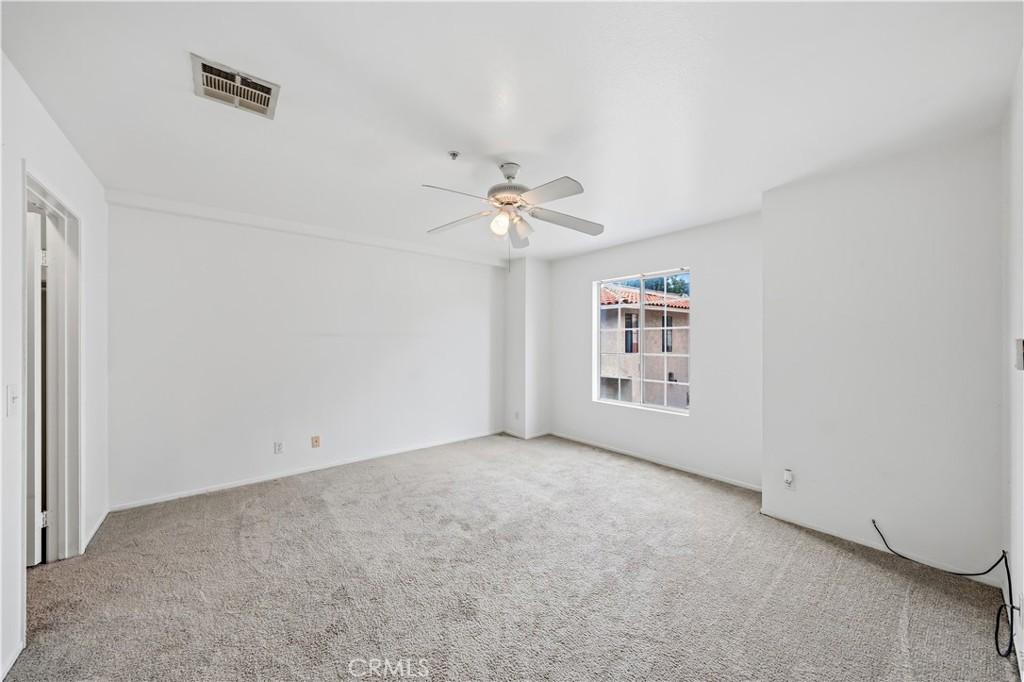 8317 College Avenue Whittier, CA 90605 - Photo 25 of 41 an empty room with a ceiling fan and a window