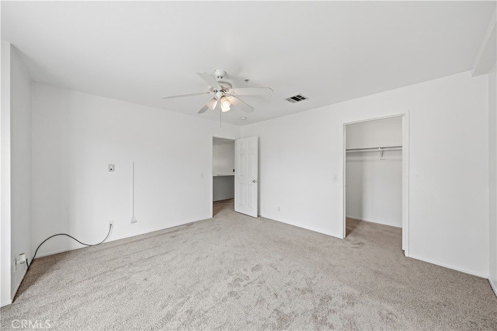 8317 College Avenue Whittier, CA 90605 - Photo 26 of 41 an empty room with a ceiling fan and window