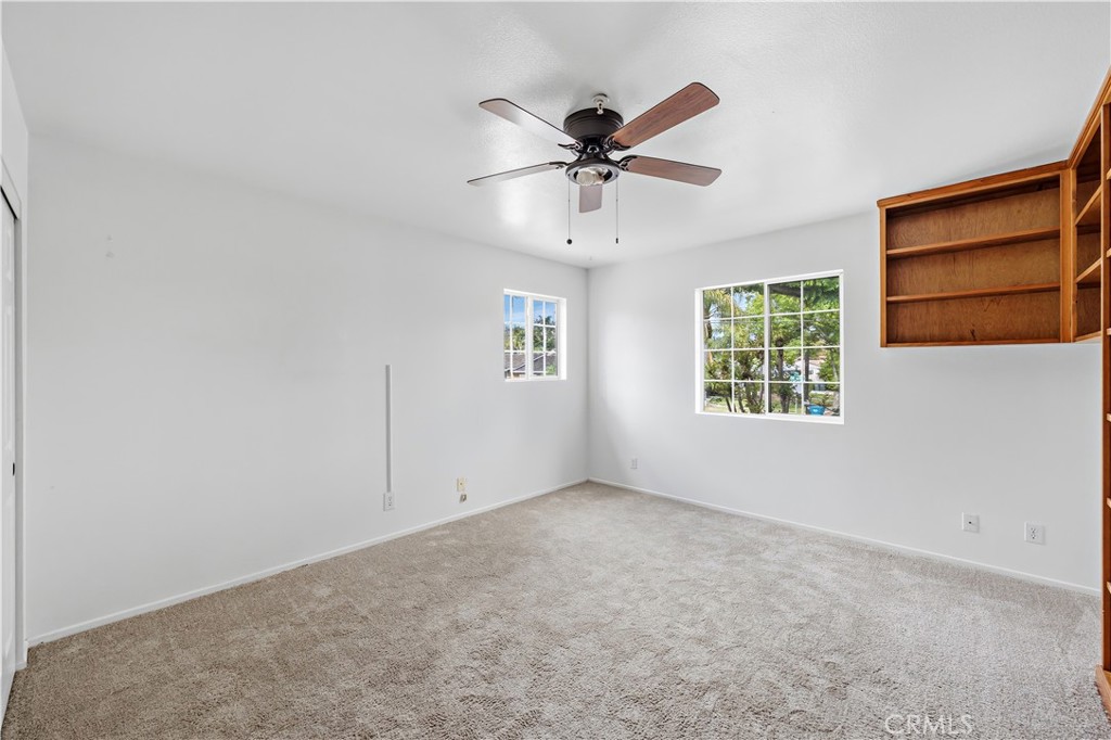 8317 College Avenue Whittier, CA 90605 - Photo 27 of 41 an empty room with windows and fan