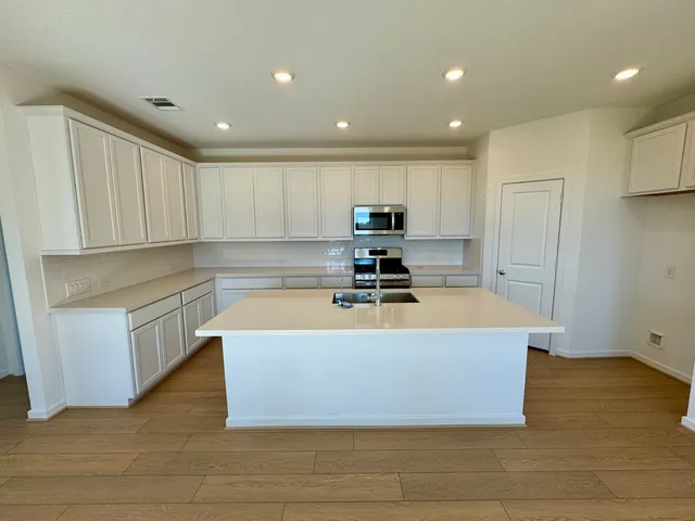 a view of kitchen with cabinets and wooden floor