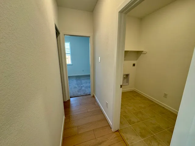 a view of a hallway with a wooden floor
