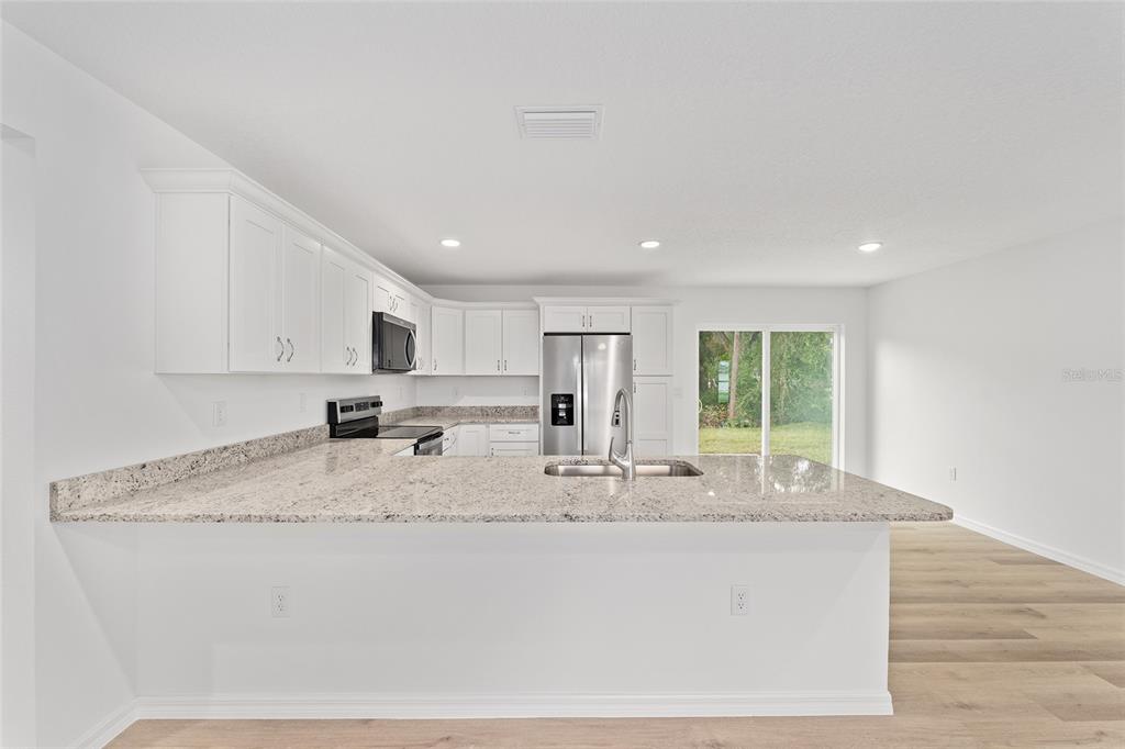 13119 Northeast 7th Loop Silver Springs, FL 34488 - Photo 19 of 51 a view of kitchen with granite countertop cabinets